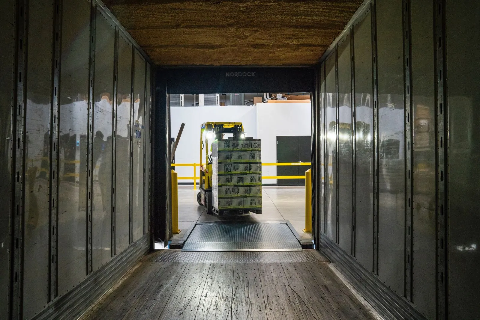 Forklift loading pallets into a container